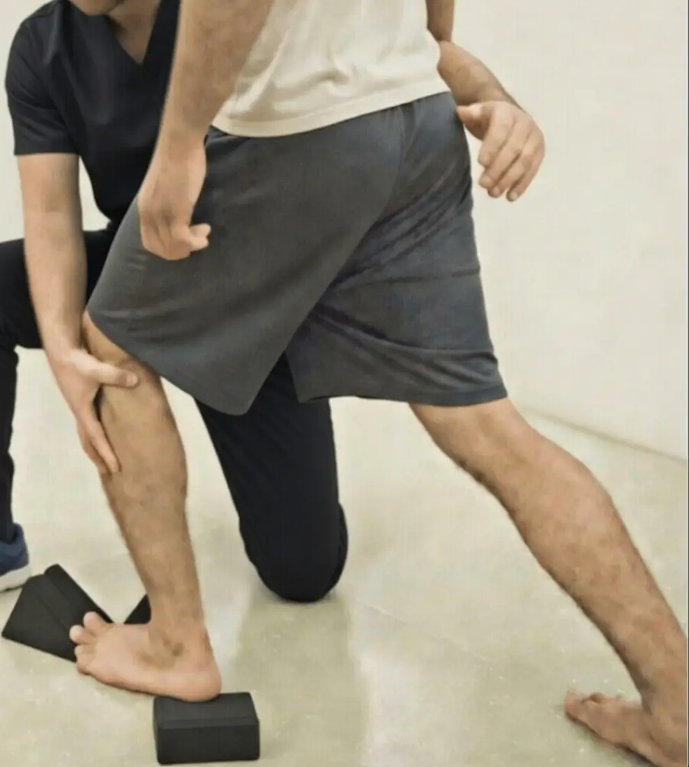 Anatomy in Motion sports injury rehab practitioner assessing patient leg movement at City Integrative Rehabilitation NYC