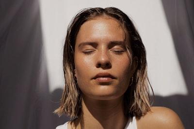 Woman with radiant, glowing skin after non-injectable facial rejuvenation in NYC